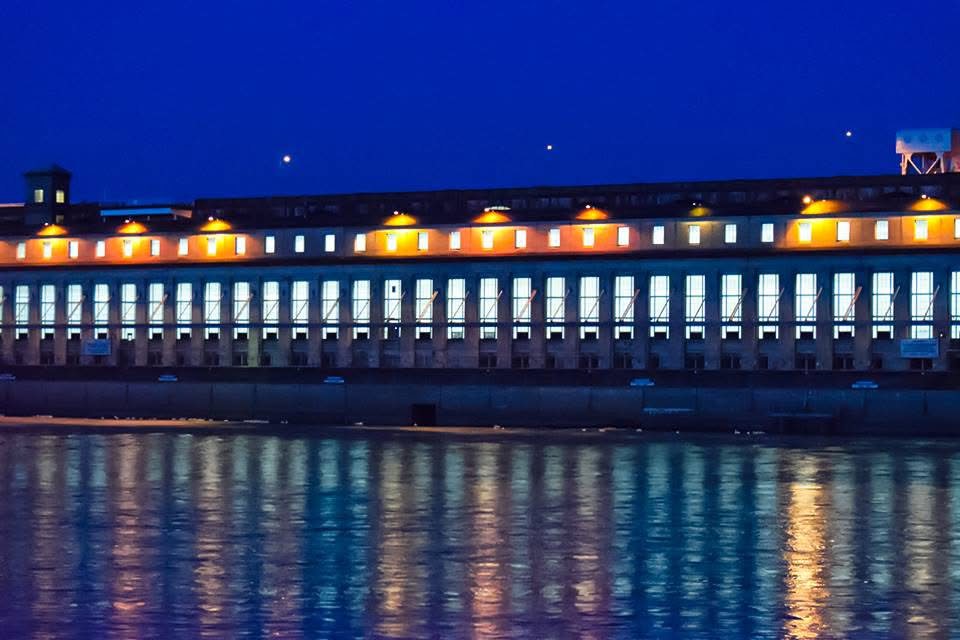 Wilson Dam illuminated at night above the Tennessee River